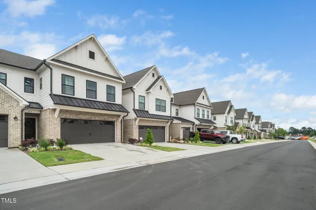 a front view of a house with a garden and plants