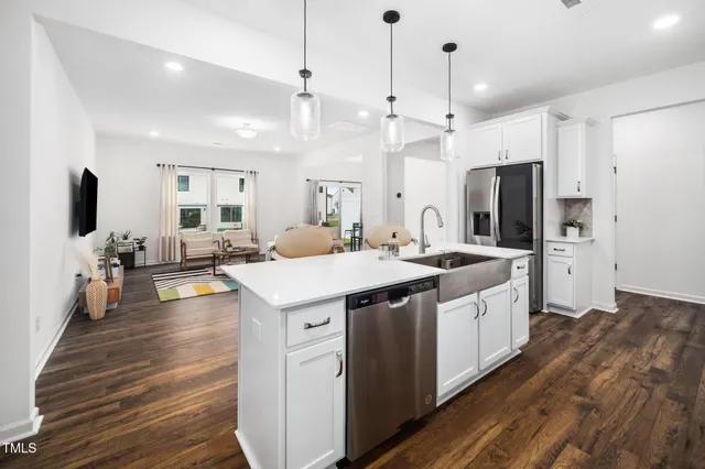 a large kitchen with stainless steel appliances kitchen island granite countertop a large island in the center