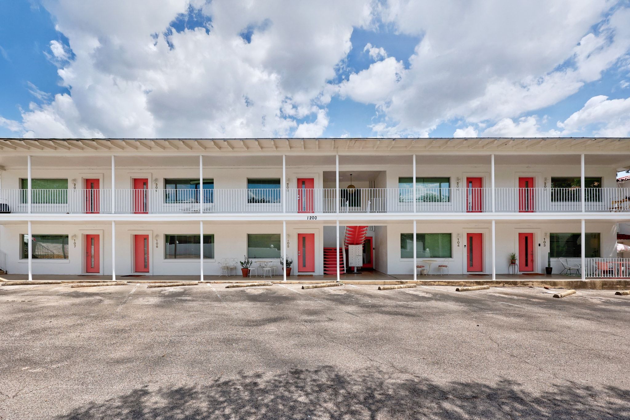 1200 Enfield Road, Unit 205 Austin, TX 78703 - Photo 14 of 22 a front view of a residential apartment building with a yard