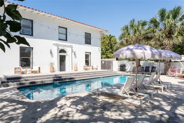 a view of house with swimming pool outdoor seating area and furniture