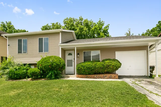 a view of a house with a yard