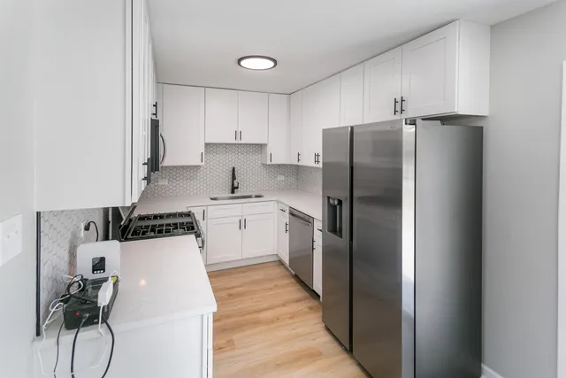 a kitchen with stainless steel appliances a refrigerator and a stove