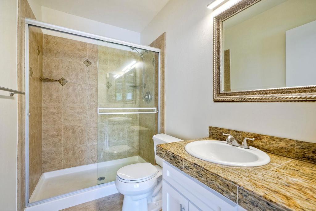 2251 Altisma Way, Unit 202 Carlsbad, CA 92009 - Photo 17 of 35 a bathroom with a sink toilet and shower