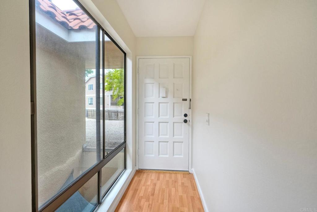 2251 Altisma Way, Unit 202 Carlsbad, CA 92009 - Photo 19 of 35 a view of a hallway with wooden floor and cabinet