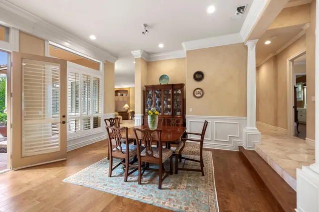a bedroom with a bed a large window and walk in closet