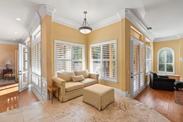 a view of a wooden house with a flower garden