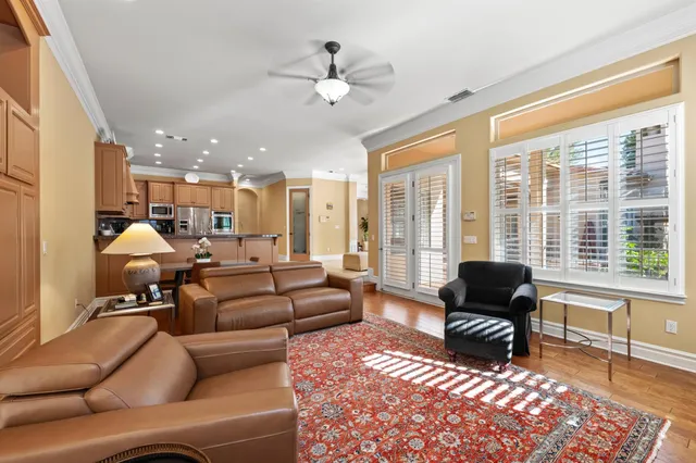 a view of a patio with couches table and chairs with wooden floor