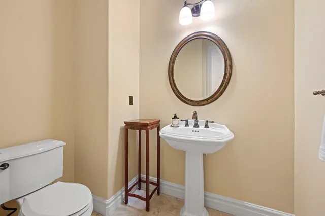 a view of a wooden house with a flower garden