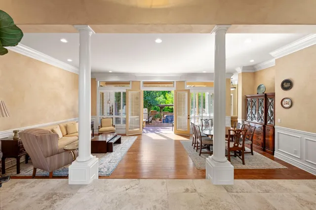 a living room with furniture ceiling fan and a rug