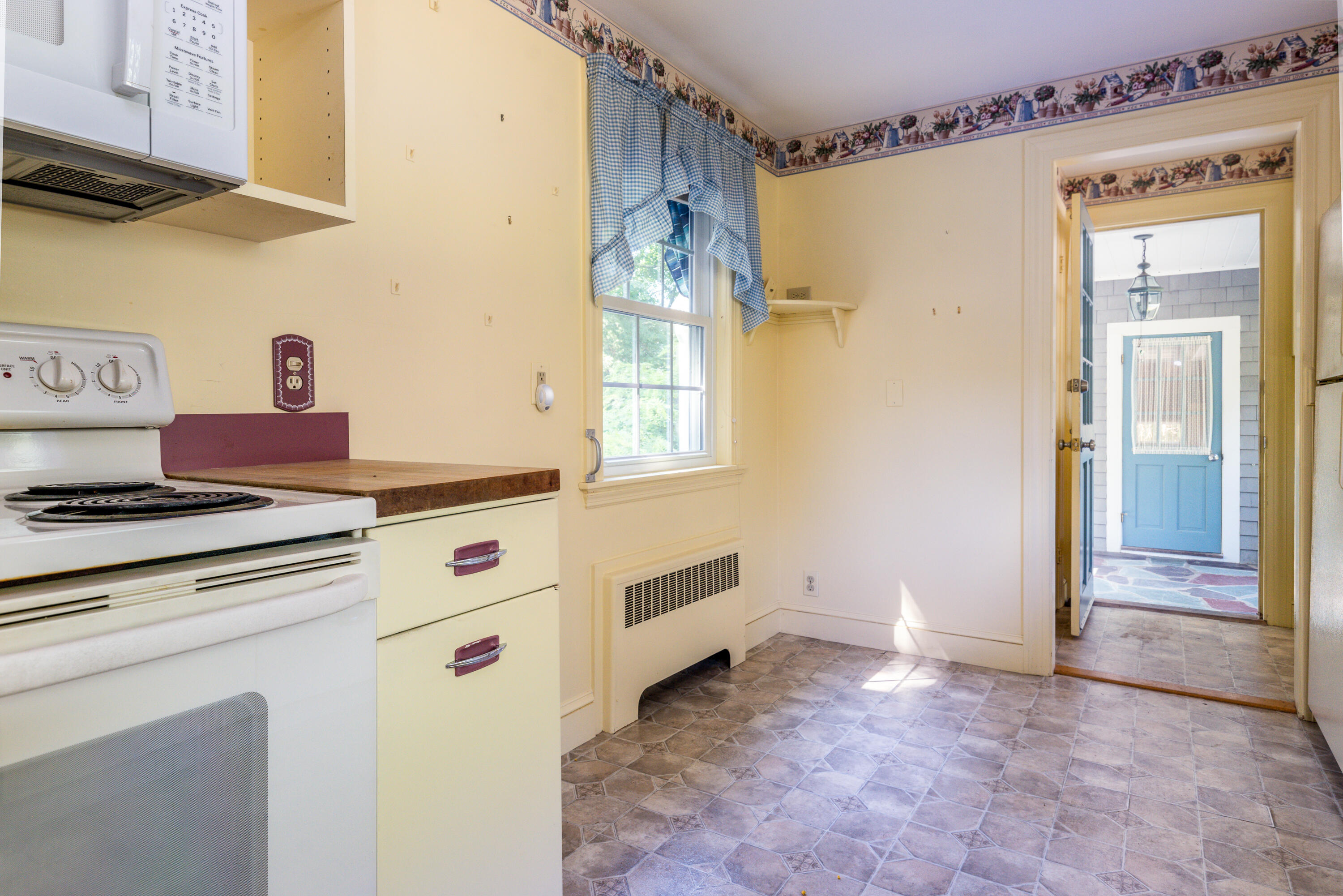 115 Old Stage Road Centerville, MA 02632 - Photo 12 of 32 a kitchen with a stove and white cabinets