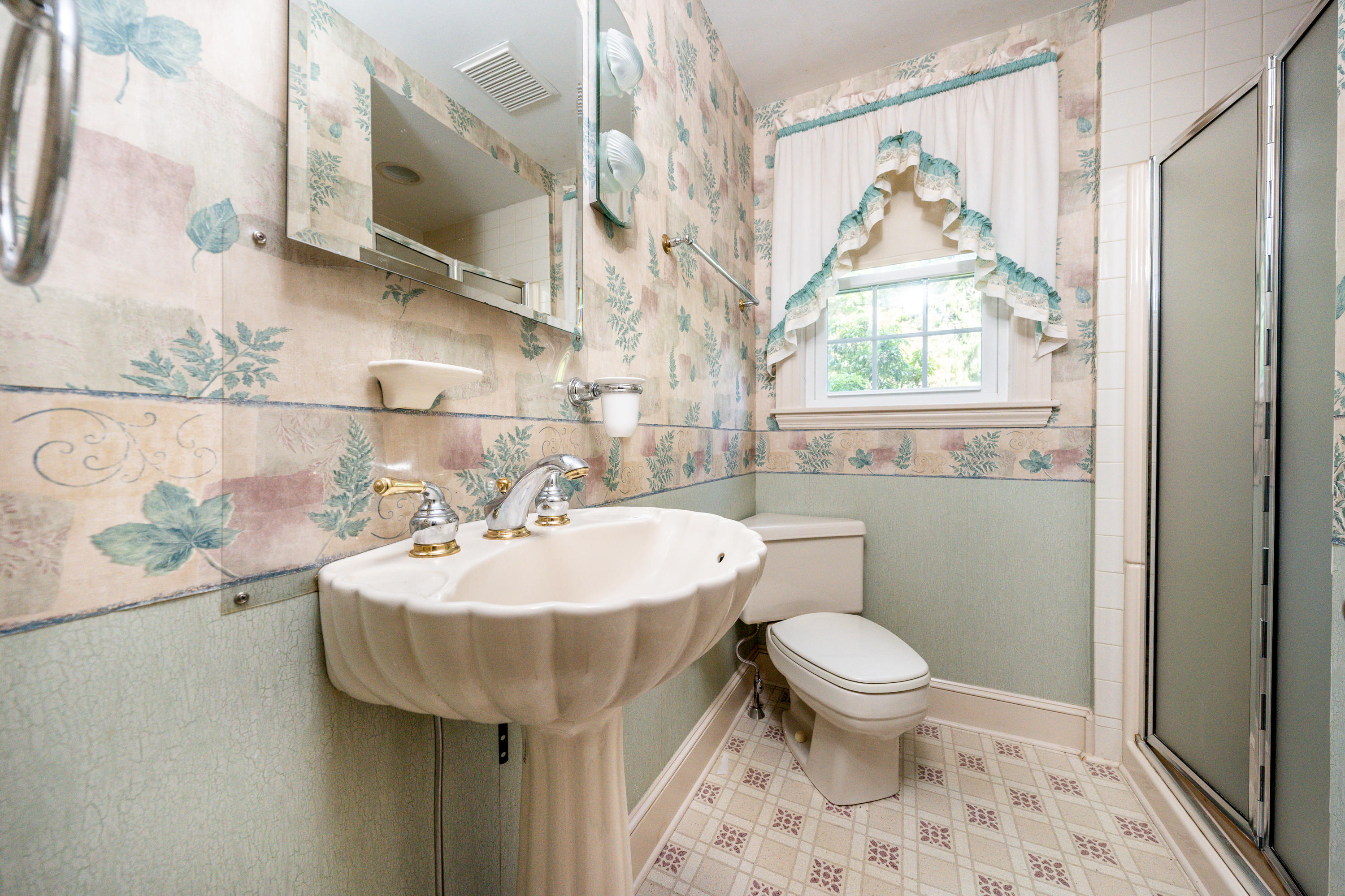 115 Old Stage Road Centerville, MA 02632 - Photo 13 of 32 a bathroom with a sink a toilet and a mirror