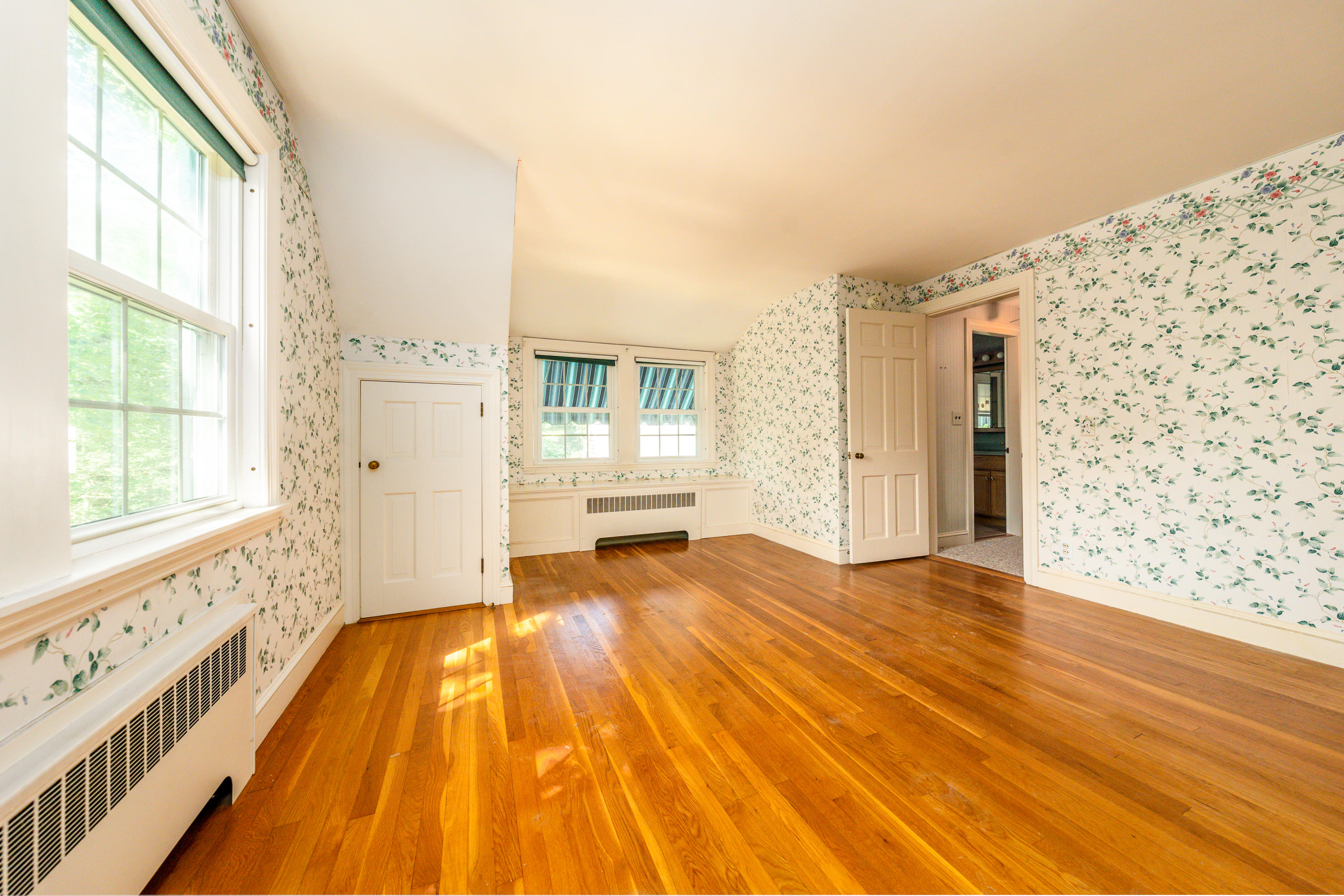 115 Old Stage Road Centerville, MA 02632 - Photo 17 of 32 a view of a bedroom with wooden floor and a window