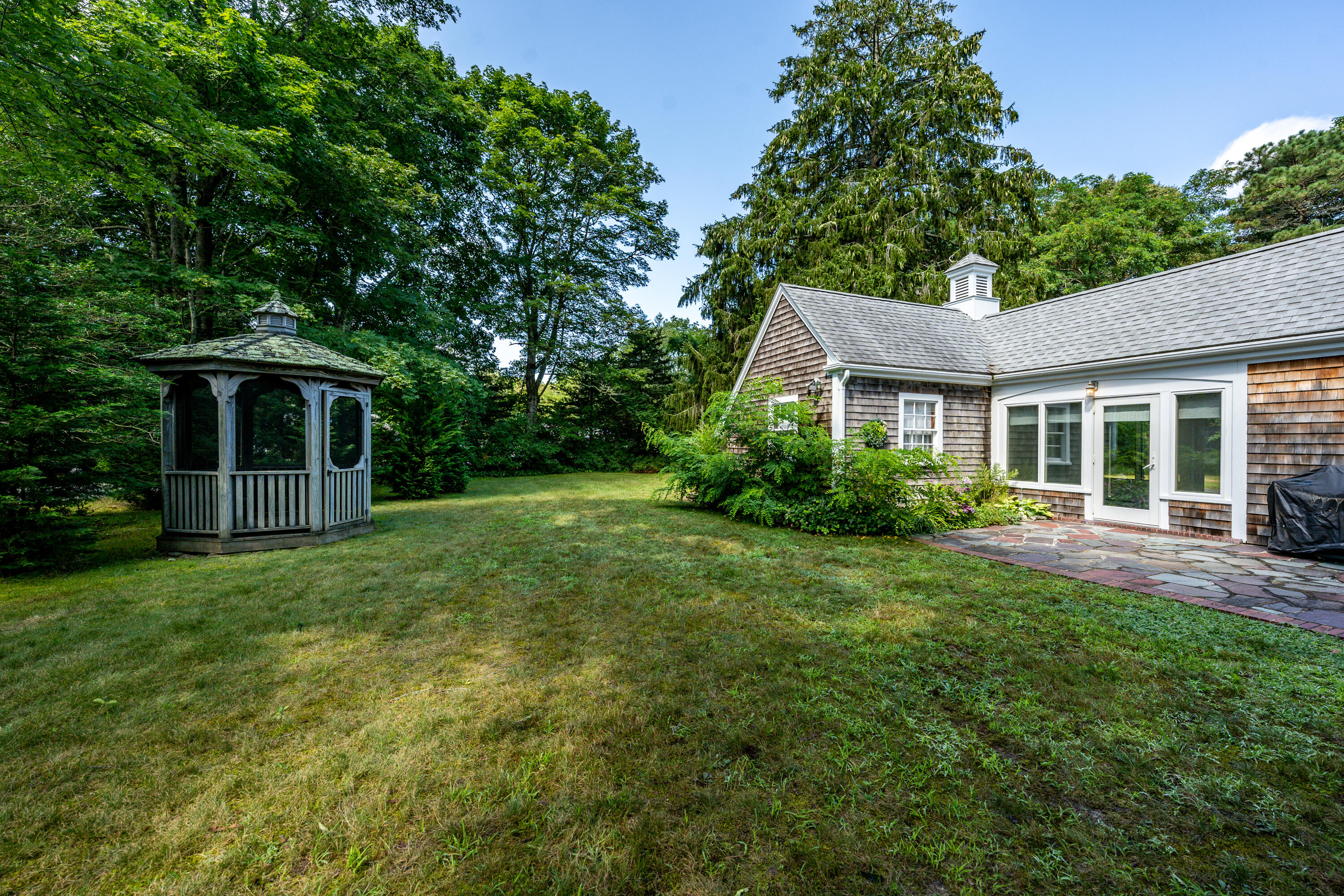 115 Old Stage Road Centerville, MA 02632 - Photo 27 of 32 a front view of a house with a yard and trees