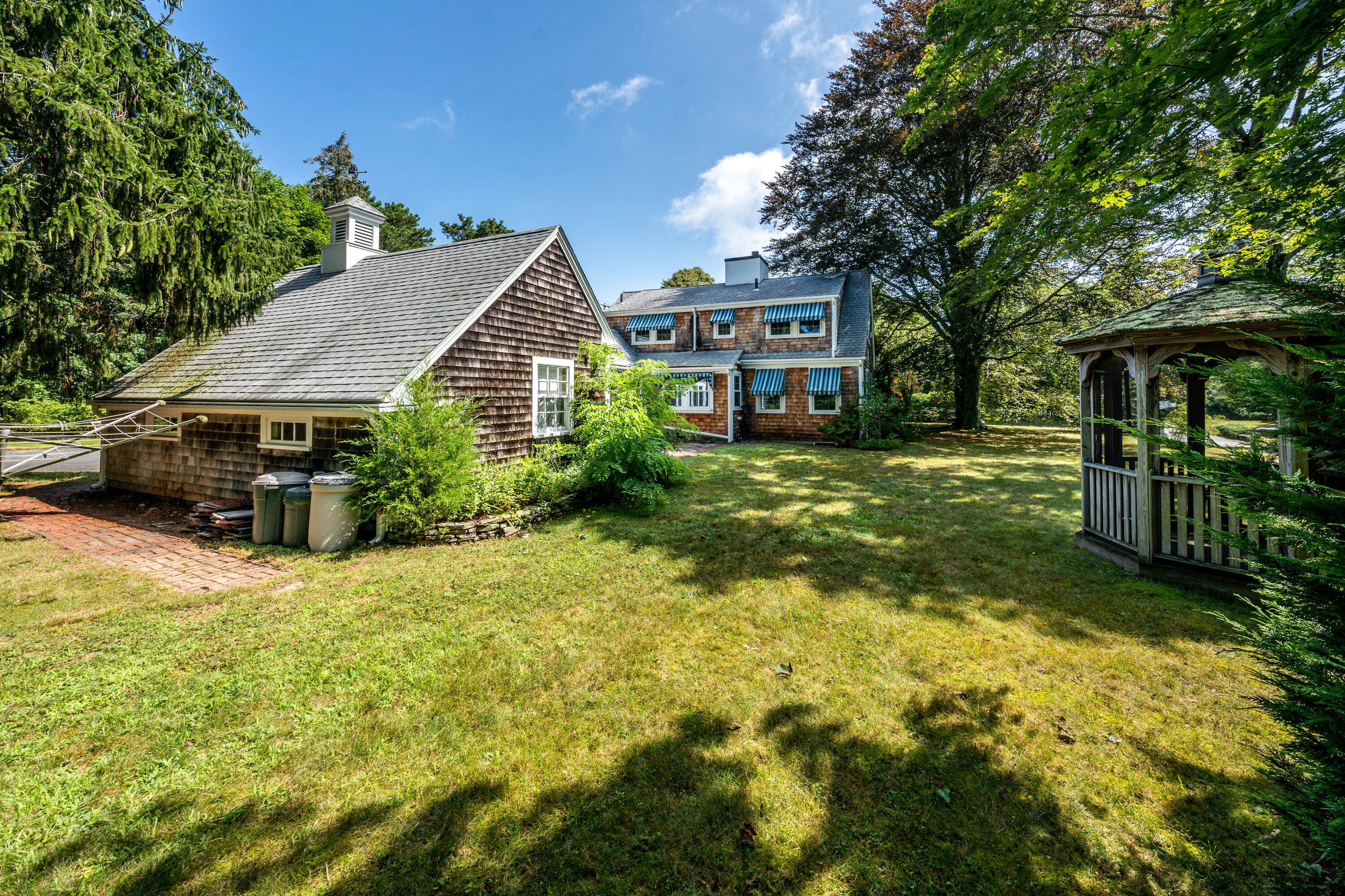 115 Old Stage Road Centerville, MA 02632 - Photo 28 of 32 a view of a house with a yard and sitting area