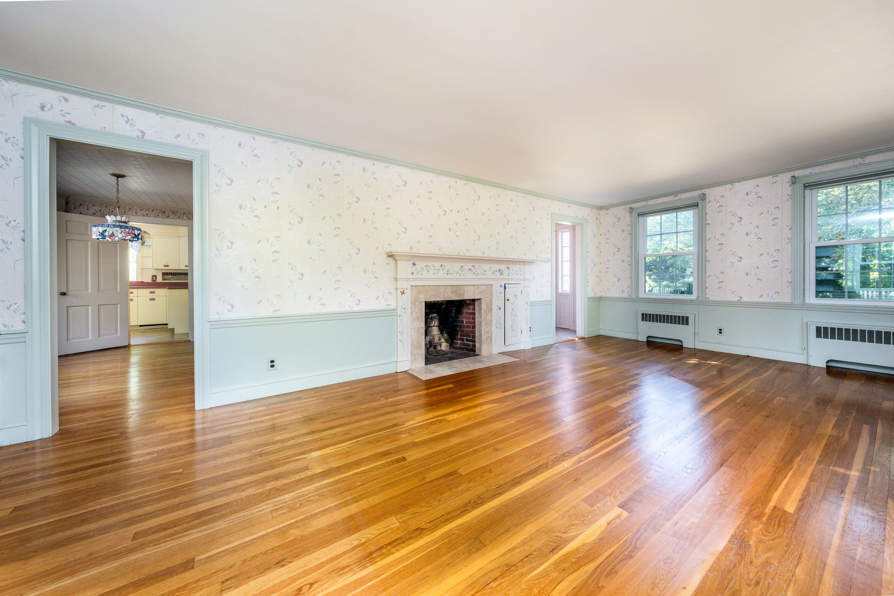 115 Old Stage Road Centerville, MA 02632 - Photo 3 of 32 an empty room with wooden floor and windows