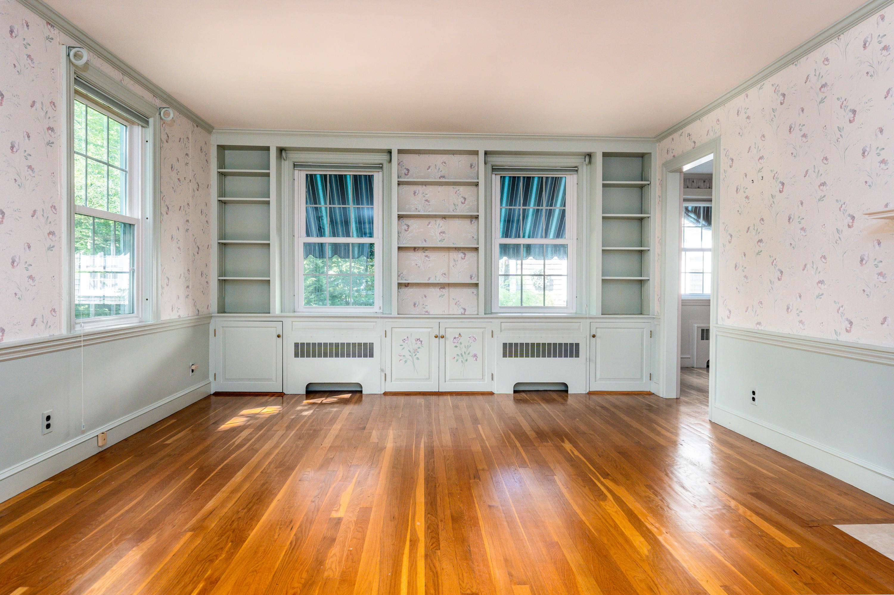 115 Old Stage Road Centerville, MA 02632 - Photo 4 of 32 an empty room with wooden floor and windows