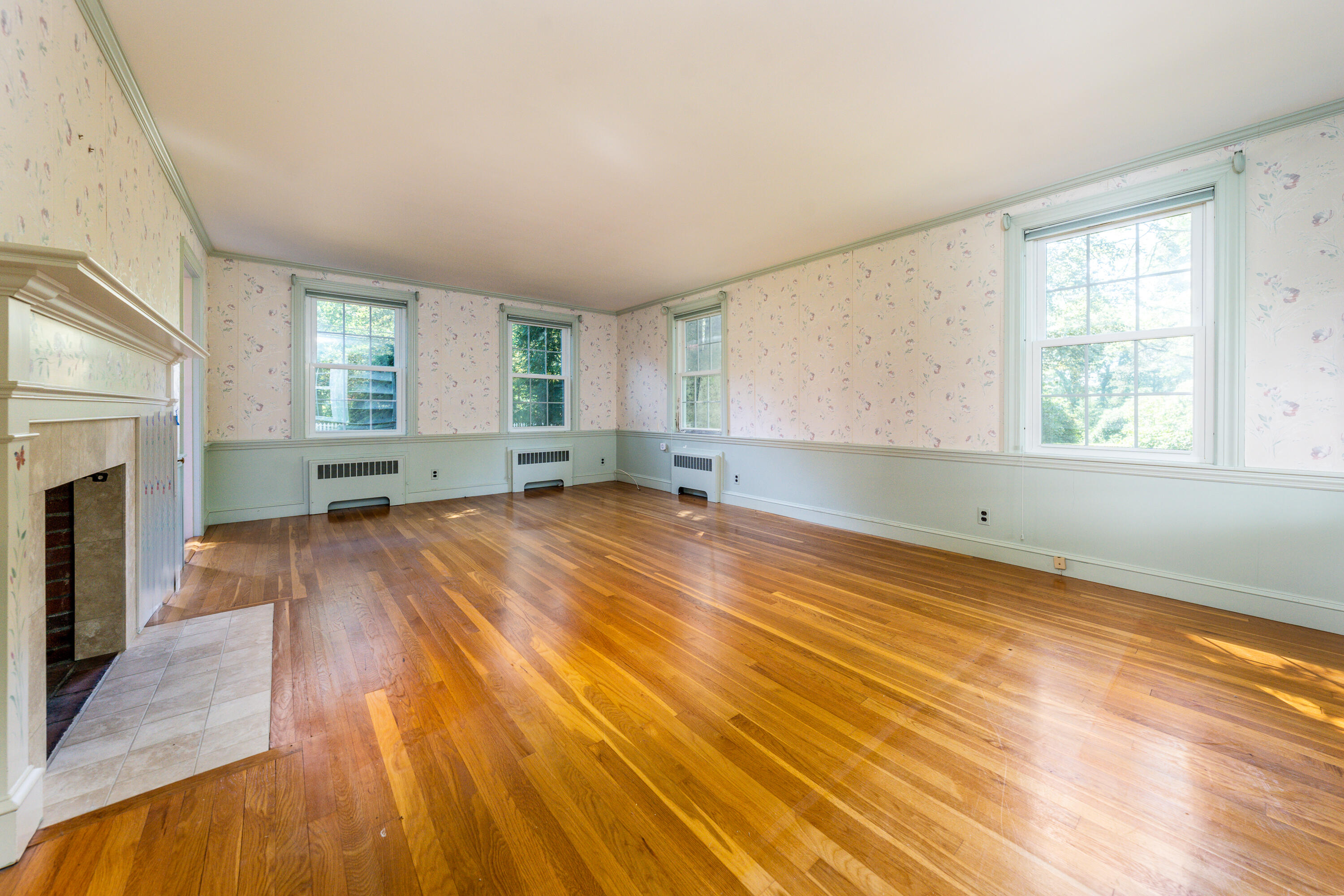 115 Old Stage Road Centerville, MA 02632 - Photo 5 of 32 a view of empty room with wooden floor and fireplace