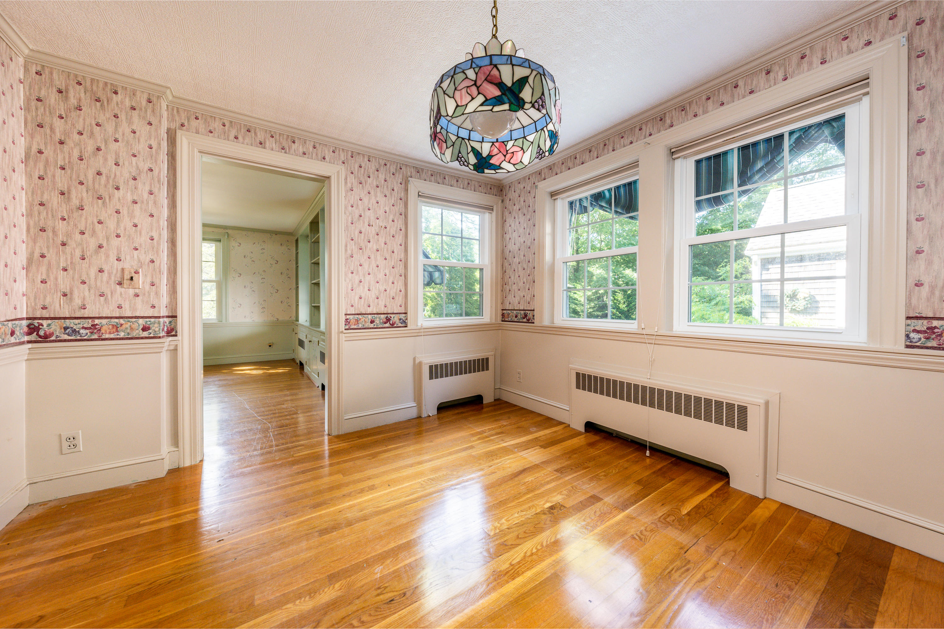 115 Old Stage Road Centerville, MA 02632 - Photo 8 of 32 a view of an empty room with wooden floor and a window