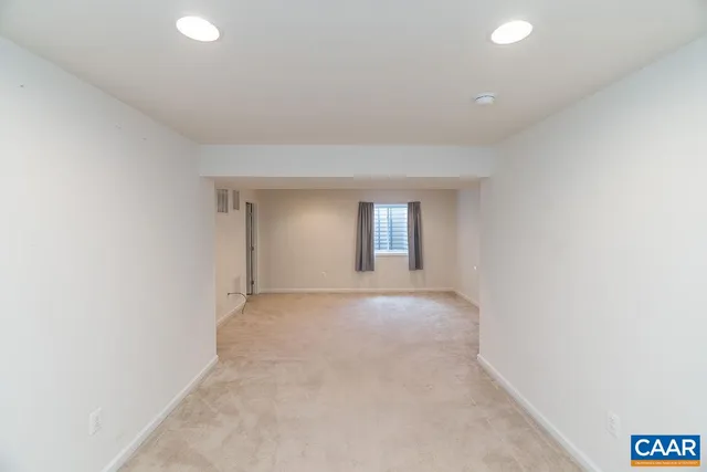 an empty room with windows and entrance