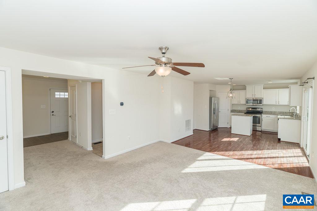 258 Larchmont Circle Ruckersville, VA 22968 - Photo 4 of 40 a view of a kitchen with wooden floor and a ceiling fan