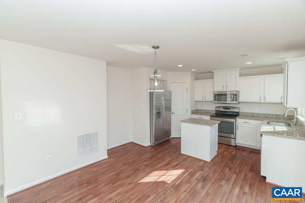 258 Larchmont Circle Ruckersville, VA 22968 - Photo 7 of 40 a kitchen with a refrigerator and a stove top oven
