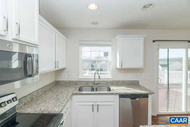 a kitchen with a sink stove and cabinets
