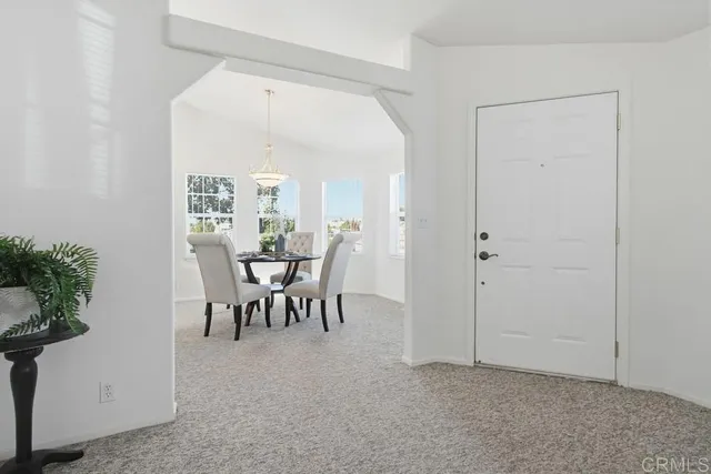 a view of a dining room with furniture window and outside view
