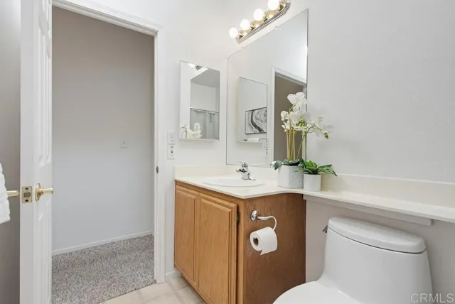 a bedroom with a bed and painting on the wall