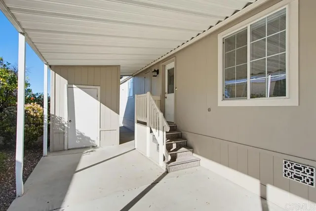 a view of a patio with table and chairs and potted plants