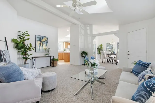 a living room with furniture potted plant and a window