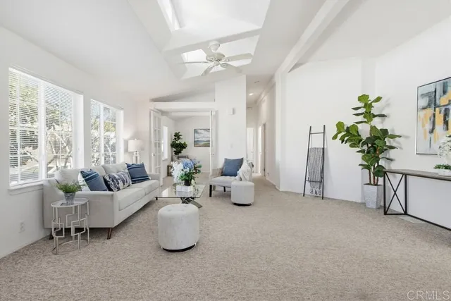 a view of a livingroom and a dining room with furniture