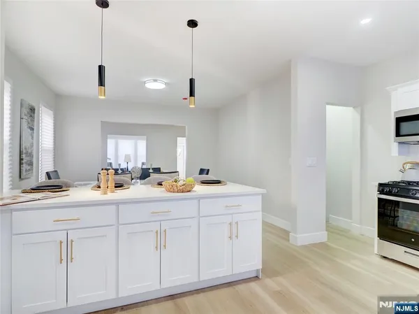 a kitchen with a stove a sink and a microwave