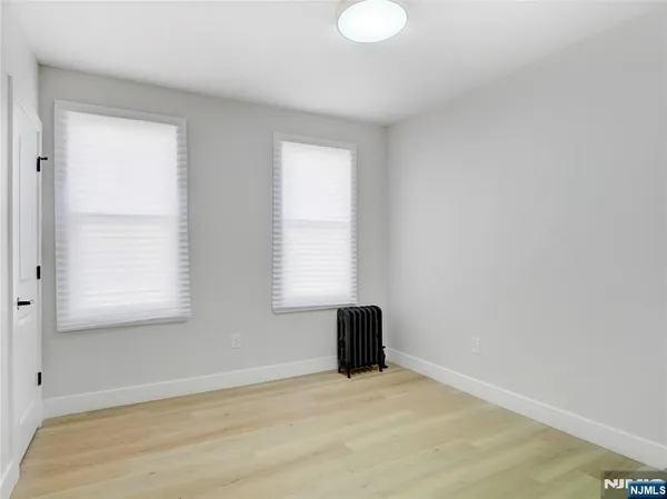 a kitchen with stainless steel appliances kitchen island granite countertop a dining table and chairs in it