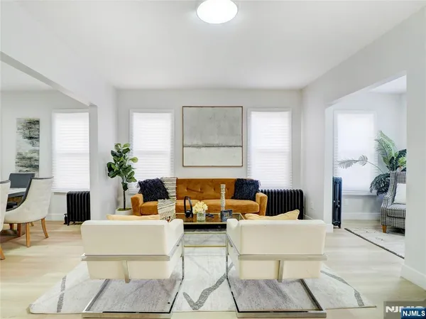 a living room with furniture and a potted plant