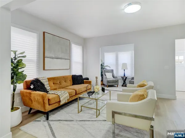 a living room with furniture and a potted plant