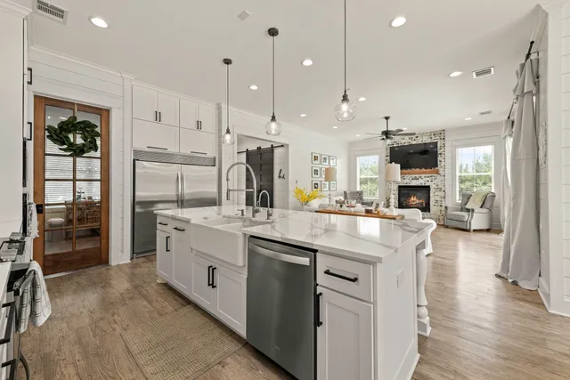 a kitchen with stainless steel appliances kitchen island granite countertop a refrigerator and a stove top oven
