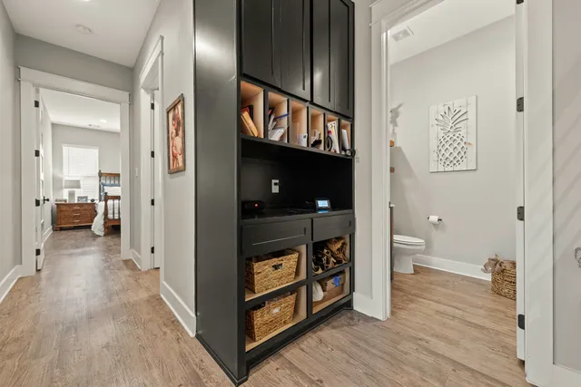 a view of a hallway with wooden floor and staircase