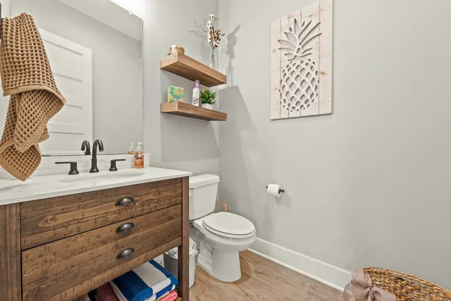 a bathroom with a toilet a sink and mirror