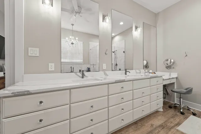 a bathroom with double sink and a mirror