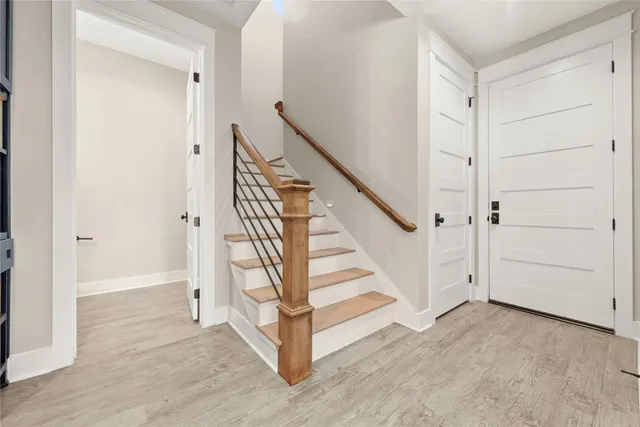 a view of front door with hallway and stairs