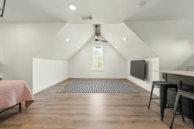 a kitchen with a sink cabinets and wooden floor