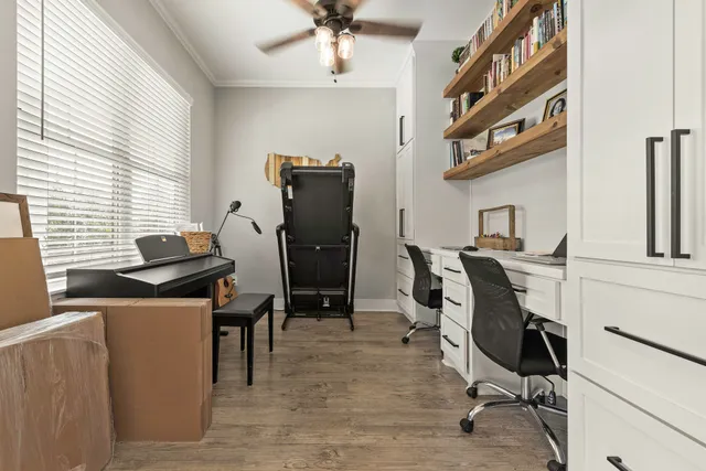 a view of a workspace with furniture and a window