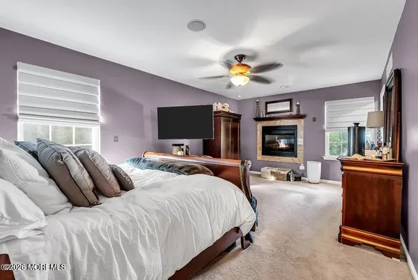 a spacious bedroom with a bed and a flat screen tv