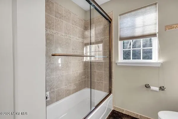 a bathroom with a glass shower door