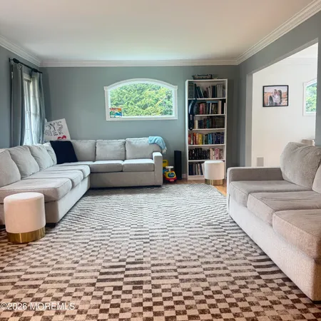 a living room with furniture or couch and a bookshelf