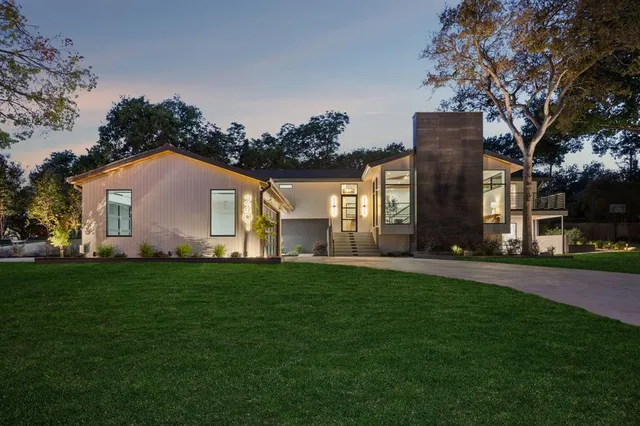 a front view of a house with a garden