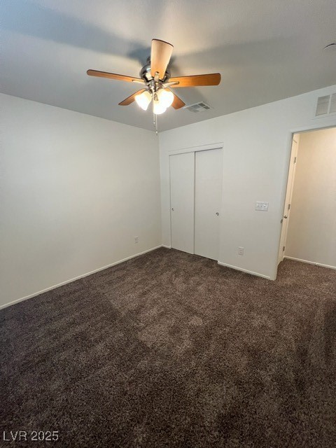 4561 Woolcomber Street Las Vegas, NV 89115 - Photo 6 of 19 Unfurnished bedroom with dark carpet, a closet, and a ceiling fan
