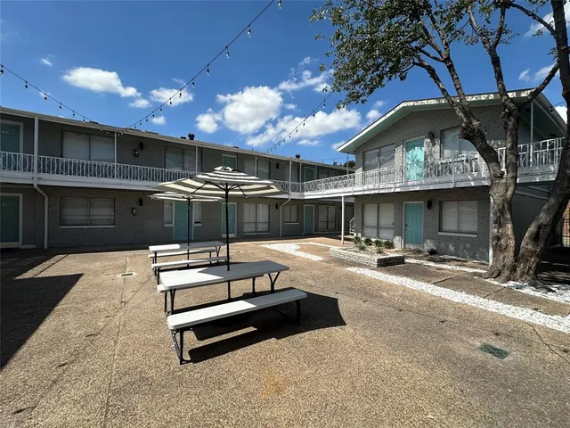 a view of a patio with a table and chairs