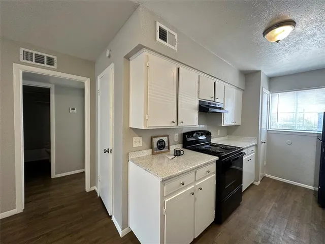 a kitchen that has a sink and a stove in it