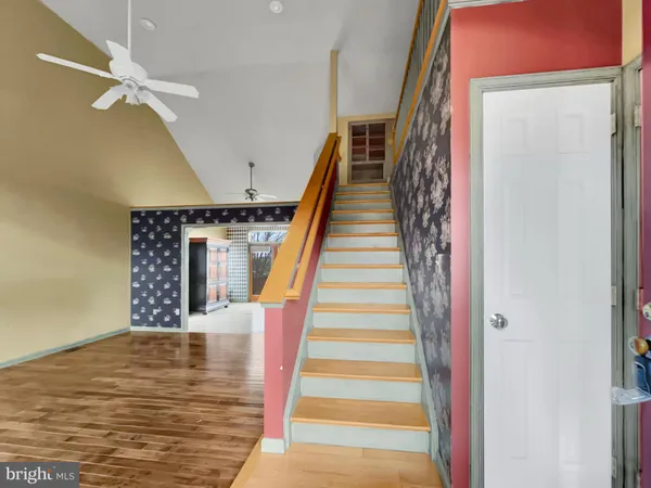 a view of staircase with white walls and railing